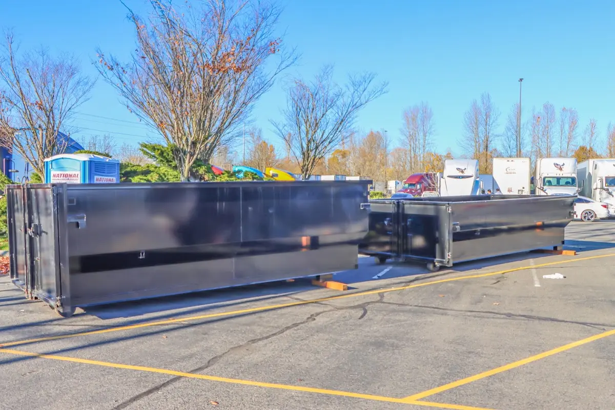 Professional dumpster rental service with roll-off container on residential driveway in Gonzales